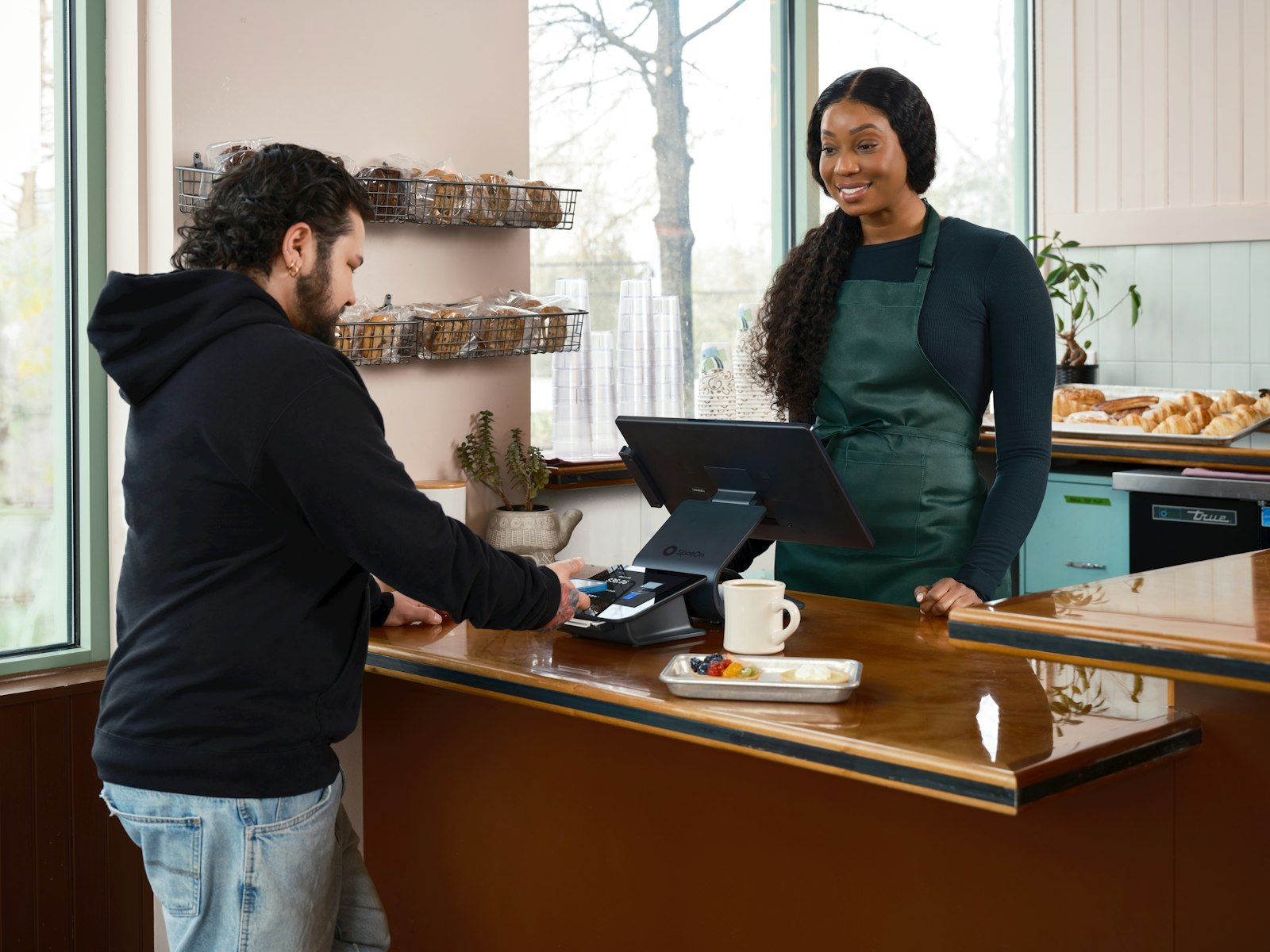 Friendly shop owner serving a customer at the counter